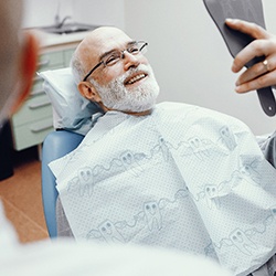 Man at dentist smiling with dental implants in Assonet