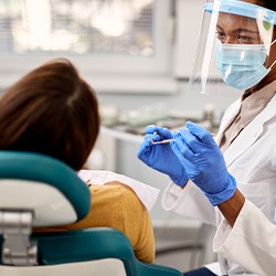 Dentist talking to patient during exam