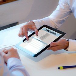 Patient reviewing dental insurance on tablet