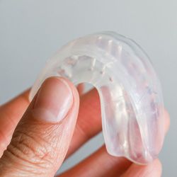 Patient holding clear mouthguard