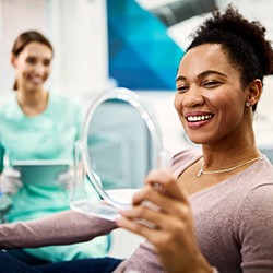 Woman smiling at reflection in mirror