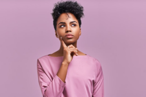 Woman in a questioning pose wonders whether toothaches are emergencies 